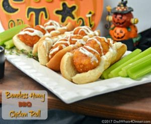 Three Boneless Honey BBQ Chicken Roll with Creamy Ranch Sauce on a plate with celery for a quick and simple trick or treat night snack you can make with your kids.
