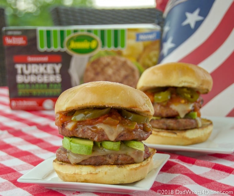 Two Firecracker Grilled Turkey Burgers on table with Jennie-O box